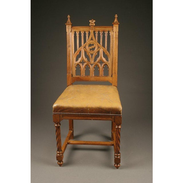 A distinctive set of six antique French Gothic-style side chairs dating to circa 1880. Crafted from walnut, these chairs...