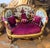French Victorian loveseat. Upholstered in luxurious burgundy velvet, this exquisite piece is beautifully accented with an...