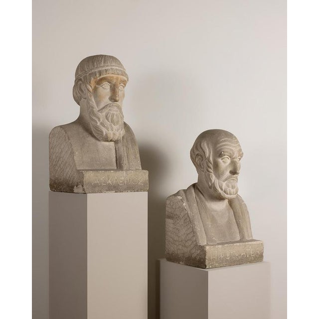 To the right of asclepius and to the left of hippocrates, a monogram composed of an m crossed by a triangle and, below, an...