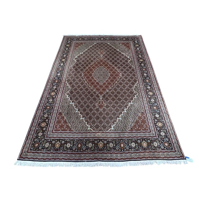 Fine Persian Tabriz Mahi Fish rug, hand knotted in Iran from 100% wool with silk highlights. Measuring 6’8” x 9’8”, the...