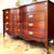 This vintage Federal-style mahogany dresser by Dixie Furniture features a graceful serpentine front, reeded corner...