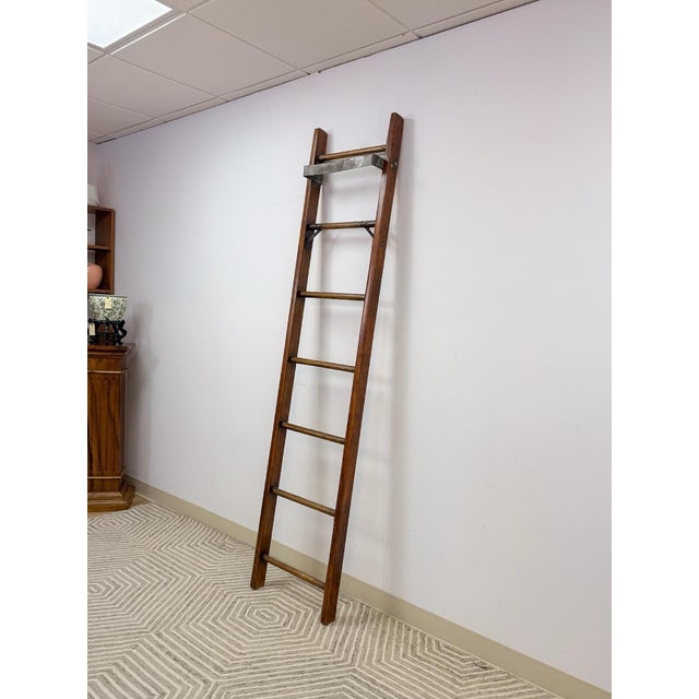 This handsome antique wood and metal library ladder is a functional and characterful vintage find. Seven solid rungs and a...