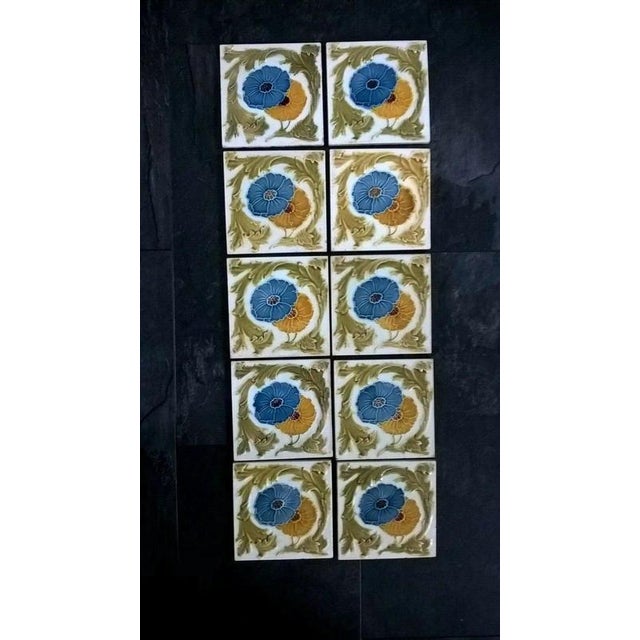 A charming set of ten antique decorative ceramic tiles, each measuring approximately 6 × 6 inches, offering authentic...