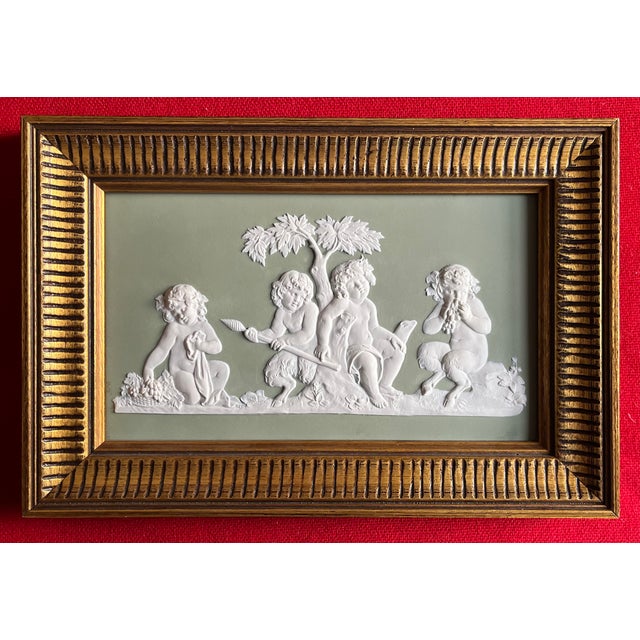Antique 18th century Wedgwood sage green jasperware plaque depicting faun-like putto reclining beneath a tree, circa 1790....