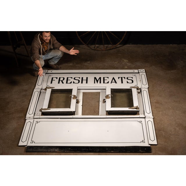 Massive porcelain enamel coller front section with raised-letter signage reading "FRESH MEATS", accompanied by twin...