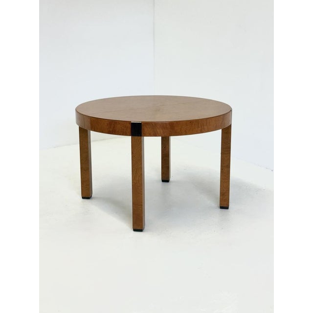 This elegant round dining table by Grange from 1988 is crafted from burl elm with refined details of Macassar wood . The...