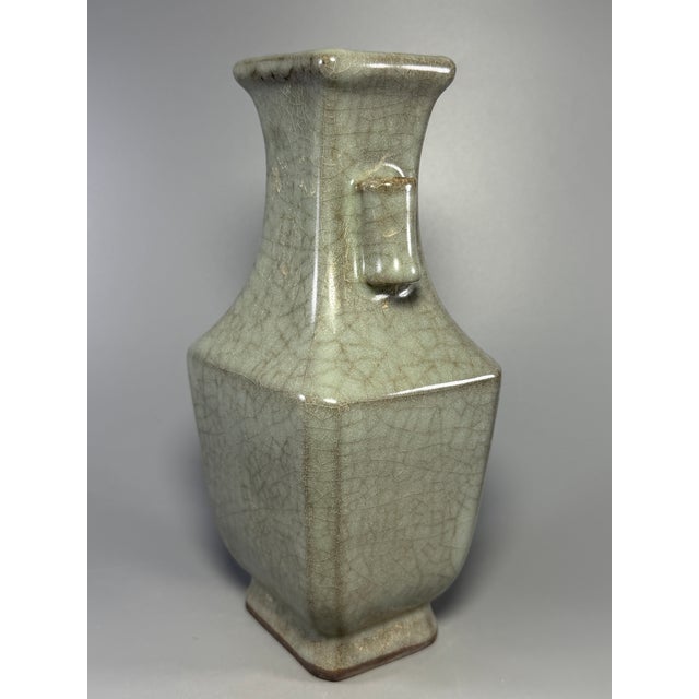 This is a beautiful Chinese Guan‑style celadon square vase with double ear handles. It features a fine crackle glaze all...