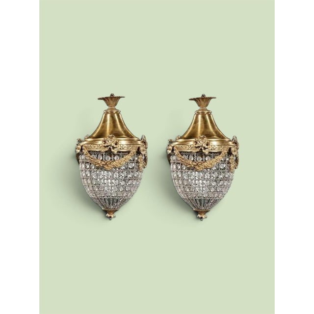 Up for consideration is a beautiful vintage pair of crystal and gold, bow and garland pendant chandeliers. These would...