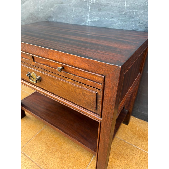 Pair of Spanish neoclassical style bedside tables crafted in solid wood, dating to the mid-20th century. Inspired by...