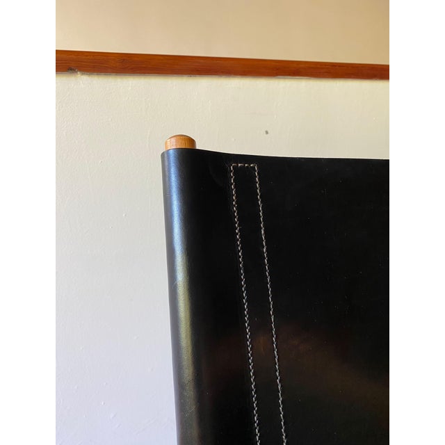 Danish safari chair made by Hyllinge Mobler, with seat and back in thick stitched harness leather, black, and birch frame....