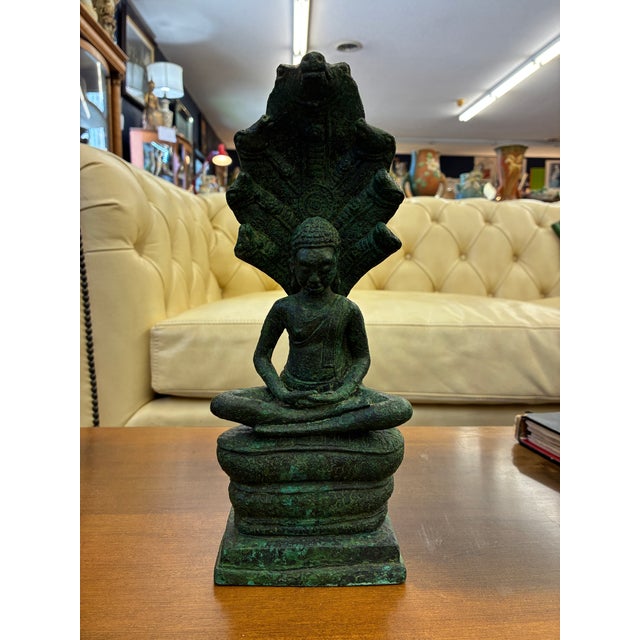 Ancient Khmer's most venerated icon is the Buddha seated on the throne-like coils of Muchalinda. This superbly cast bronze...