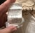 This Pottery Barn decorative pillow cover measures 22 by 22 inches and features a beige color with an elegant stitched...