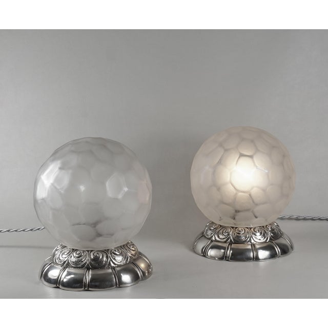 GENET & MICHON A rare pair of French 1925-1930 art deco table lamps in nickel plated solid brass or bronze holding globes...