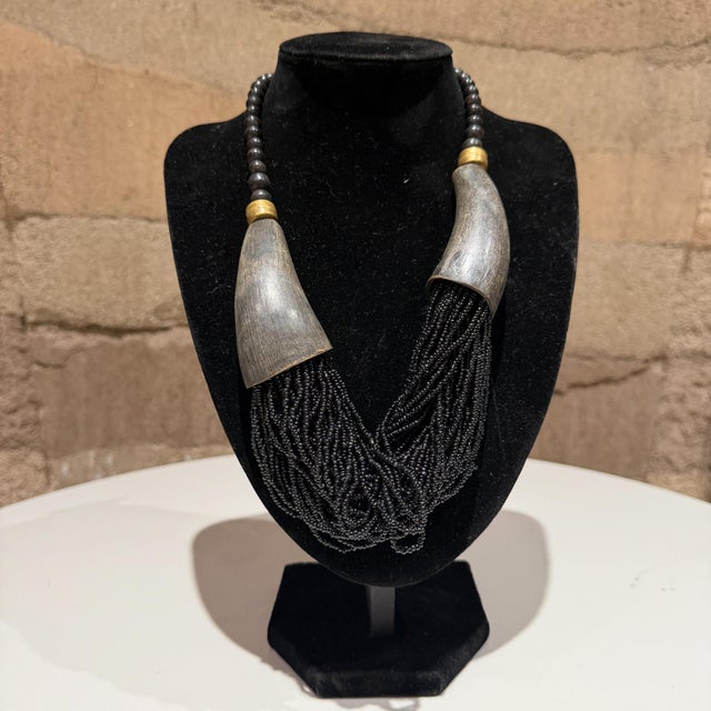For your consideration, a multi-strand black bead necklace, often associated with tribal or boho-style jewelry. Similar...