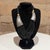 For your consideration, a multi-strand black bead necklace, often associated with tribal or boho-style jewelry. Similar...