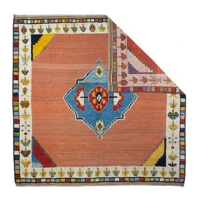 This rug hails from Fars Province, SW Persia, and features an abrashed rust-red field with a strongly abrashed...