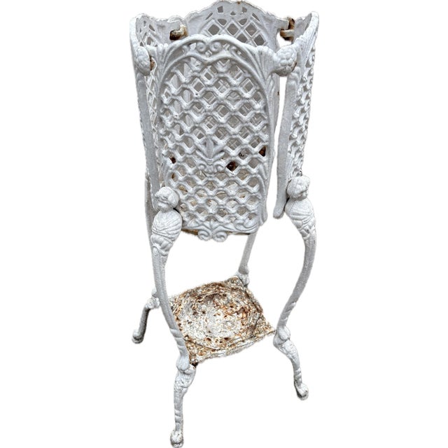 Lovely French iron planter with patina and cherub design on legs.