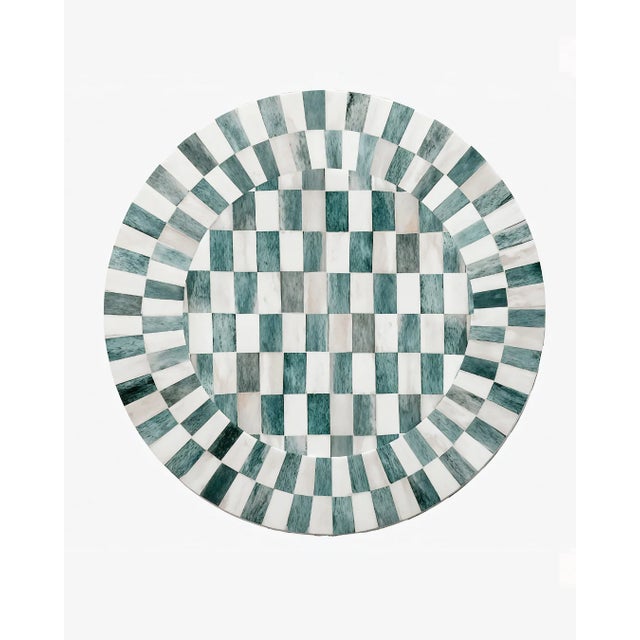 The Bone Inlay Charger in Seafoam captures a soft elegance, contrasting ivory bone with a refreshing seafoam green...