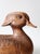 This mid-century carved wood duck features a softly rounded form, hand-carved feather detailing, and warm, naturally aged...