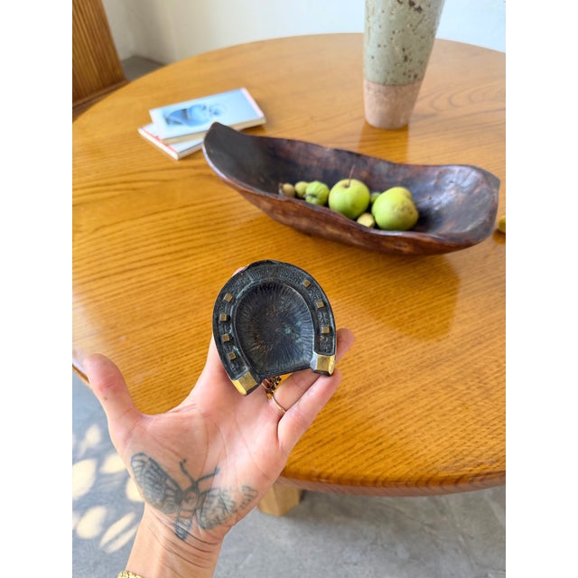 Antique small ashtray in a Brutalist style, shaped like a horseshoe, in patinated bronze. We love the patina from use, the...