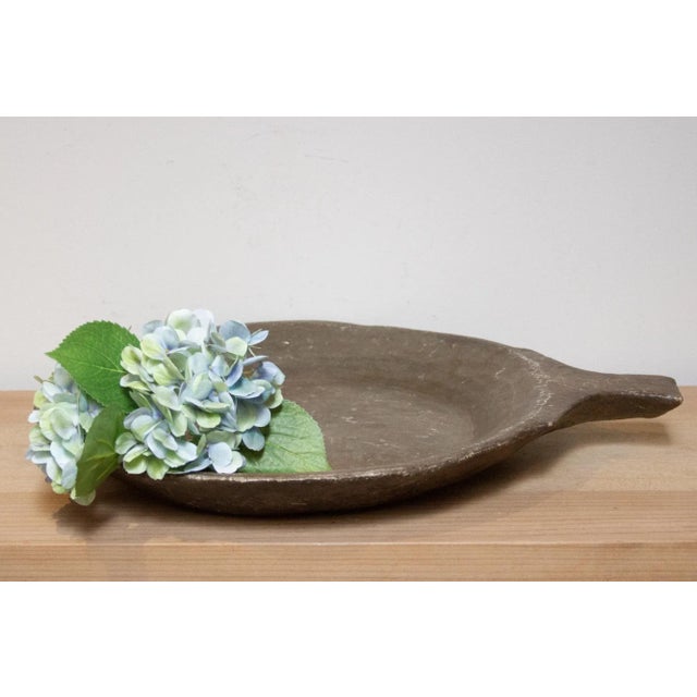 An antique Indian parat stone bowl, a relic from the past cherished for its practicality and rustic charm. Crafted from...