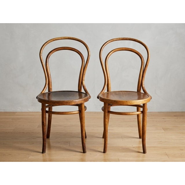 An authentic pair of turn of the century antique bentwood side chairs manufactured by the prestigious Austro-Hungarian...