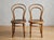 An authentic pair of turn of the century antique bentwood side chairs manufactured by the prestigious Austro-Hungarian...