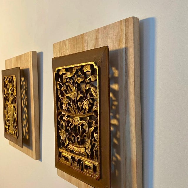 This pair of early 20th-century Chinese carved panels is a fine example of traditional openwork and giltwood...