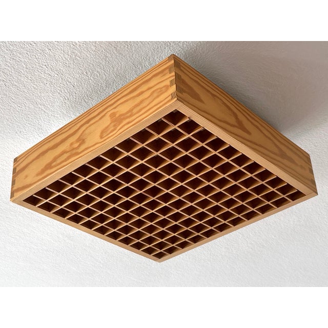 Elegant and highly decorative mid-century modern square ceiling lamp or flush mount with removable wood grids. Designed &...
