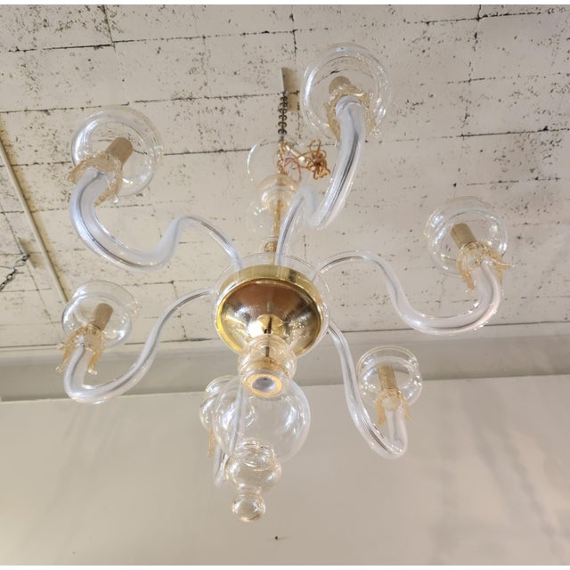 Clear glass with gold trimmings, 6 lights chandelier in mint condition. Lead cord has been updated by rewiring it.