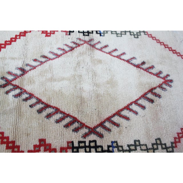 One-of-a-kind rug hand-knotted in the High Atlas Mountains of Morocco with soft organic wool. Featuring an ornate rhythmic...