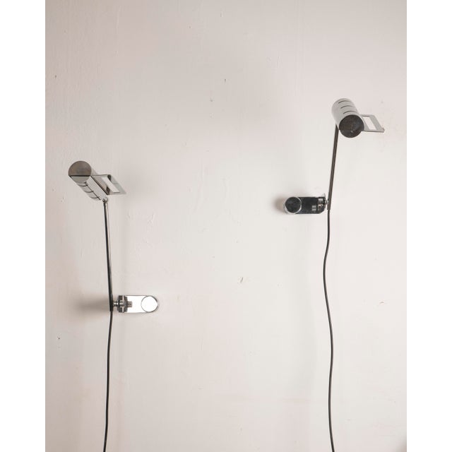An elegant pair of Italian wall sconces from the 1970s, crafted entirely from chromed metal. Each piece features a slender...