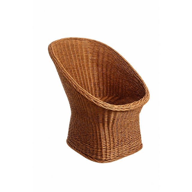 Charming pair of French wicker lounge chairs from the 1960s in a beautiful warm honey tone, featuring beautifully organic...