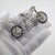 A vintage object depicting a miniature tandem bicycle, handcrafted in Arezzo, Italy between the 1980s and 1990s in...