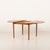 Danish vintage mid-century round teak extension table. It features one collapsing additional leaf, that hides under the...