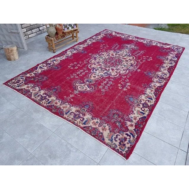 This is a vintage Turkish Oushak rug from the 1960s. The piece was hand-knotted