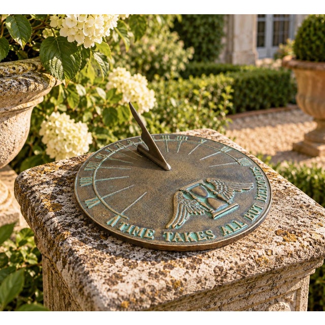 A classic vintage iron verdigris garden sundial inspired by traditional English estate landscapes, reading "Time Takes All...