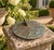 A classic vintage iron verdigris garden sundial inspired by traditional English estate landscapes, reading "Time Takes All...