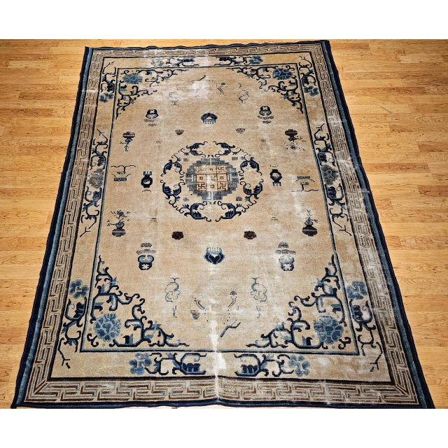 This beautiful 19th century Chinese Peking rug features a refined and balanced open field design set in a soft pale cream...