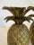 Transform your space with this stunning pair of Hollywood Regency-style brass pineapple candlestick holders, a true...