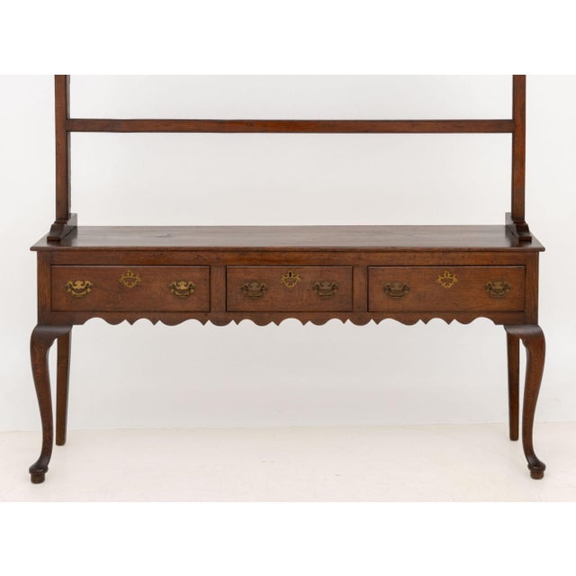 Welsh Oak Dresser, 19th century, the upper portion with two shelves and above three drawers with brass pulls atop cabriole...