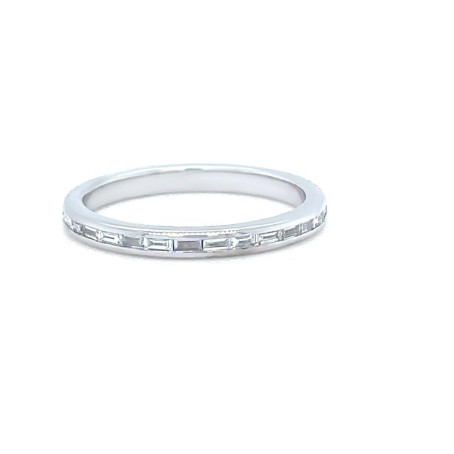 A refined full eternity ring crafted in 14ct white gold, featuring a continuous circle of baguette cut diamonds in a...