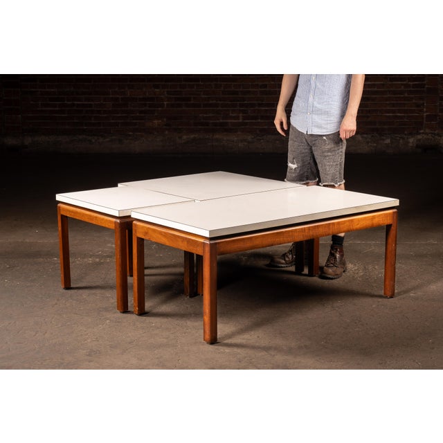 Three-piece, mid-century modern occasional table set executed in teak with white laminate tops, comprising a large...