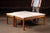Three-piece, mid-century modern occasional table set executed in teak with white laminate tops, comprising a large...