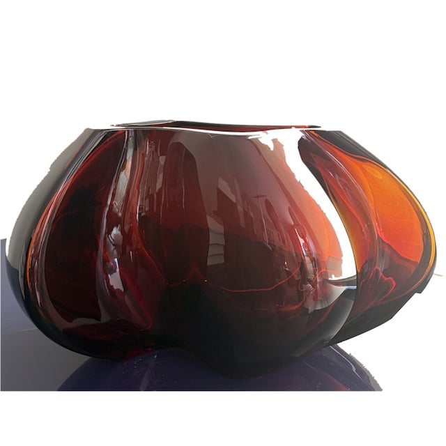 A bold, sculptural crystal vessel, hand-formed with deep folded and pinched edges that catch and refract light...