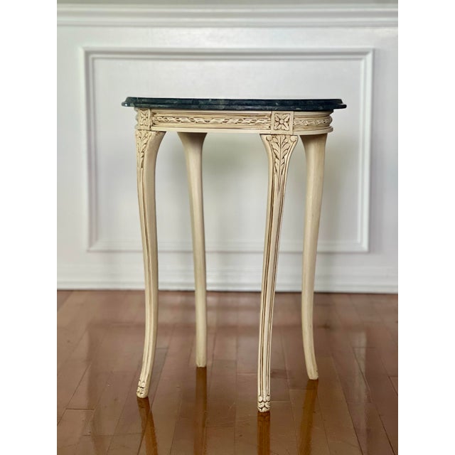 Vintage 20th century Louis XV style painted carved side table with dark green marble top. It is painted in a bisque color...