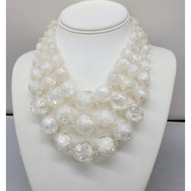1960s 3-strand goldtone chunky graduated white/clear givre art glass beads with clear saucer shaped spacer beads and hook...