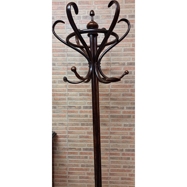 Walnut standing coat rack in perfect condition, nothing broken or cracked. It is a robust and very stable piece due to the...