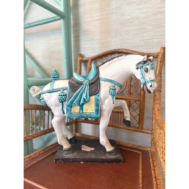 A large Tang Dynasty–style prancing horse in the classic caparisoned pose—front leg raised, head slightly lowered, and...