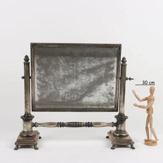 Table mirror in silver metal with coeval mirror. This piece is attributed to the mentioned designer/maker. It has no...